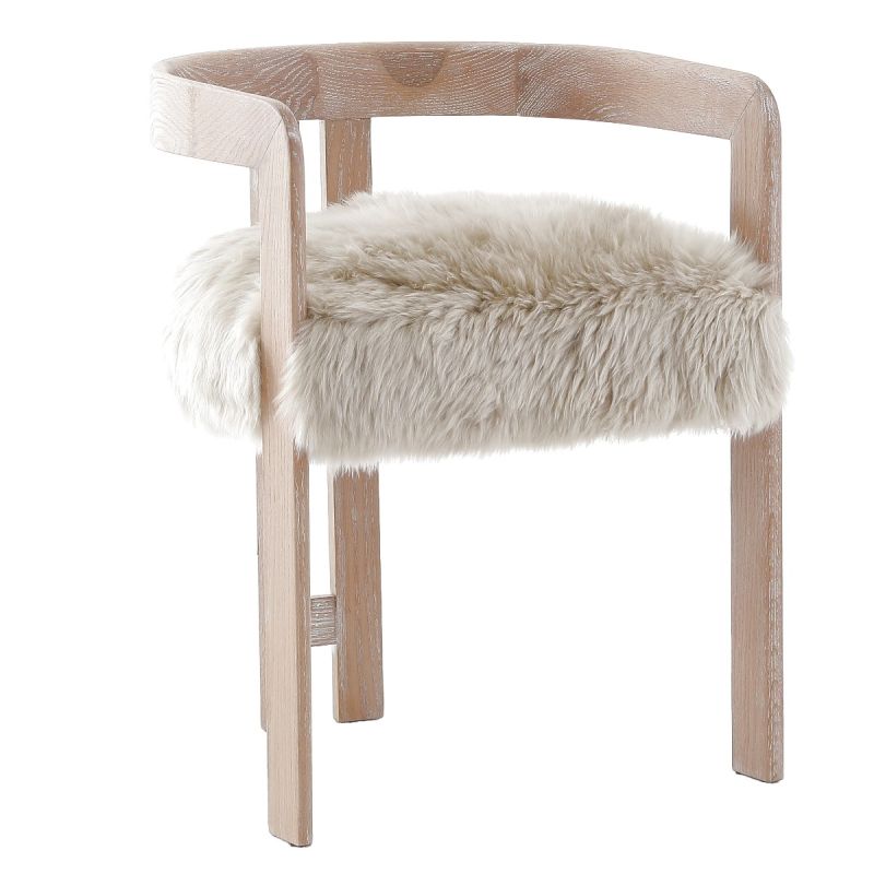 The Baaarb Dining Chair, with its real cream sheepskin seat and solid oak frame, exudes luxurious contemporary style and texture, making it a striking addition to any dining space.