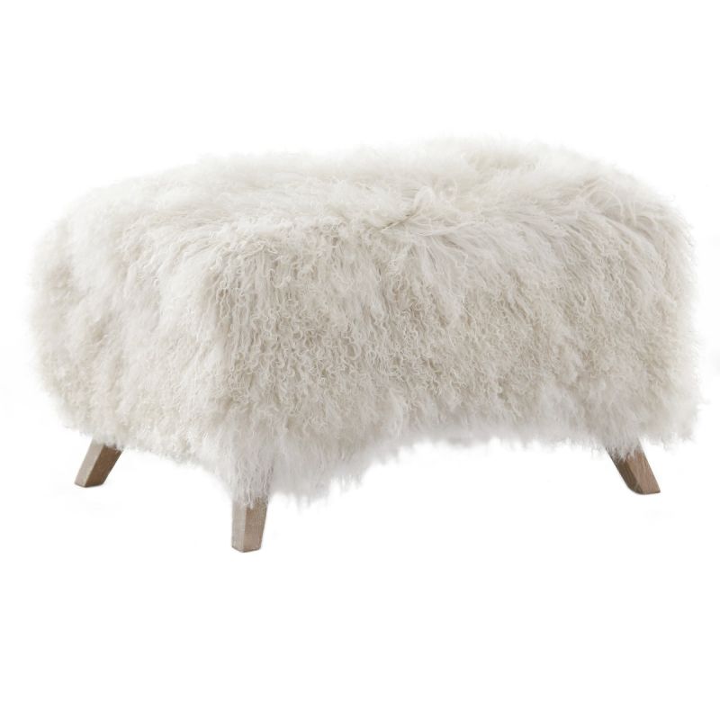 The Baaarb Ottoman by Keiichi, with solid oak legs and luxurious cream sheepskin, effortlessly complements the Baaarb Sofa or Accent Chair, adding warmth and character to any interior.
