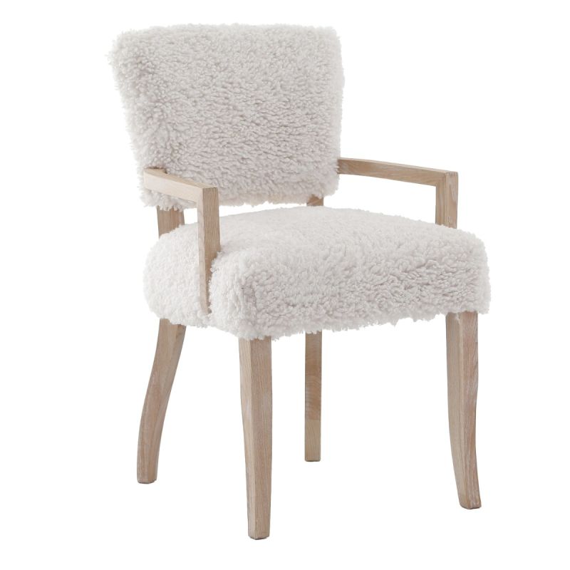 The Winnie Dining Armchair, with its faux sheepskin upholstery and solid oak frame, adds Alpine elegance and comfort, featuring solid oak arms for added support.