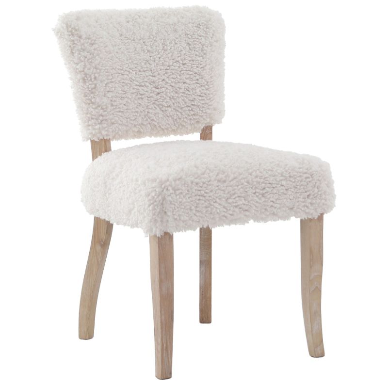 The Winnie Dining Chair, upholstered in faux sheepskin and set on a solid oak frame, brings Alpine charm and style to your dining room.