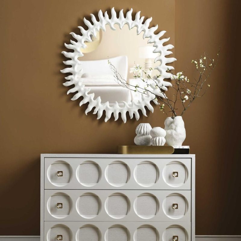Circular mirror with exquisite white frame resembling sun beams.