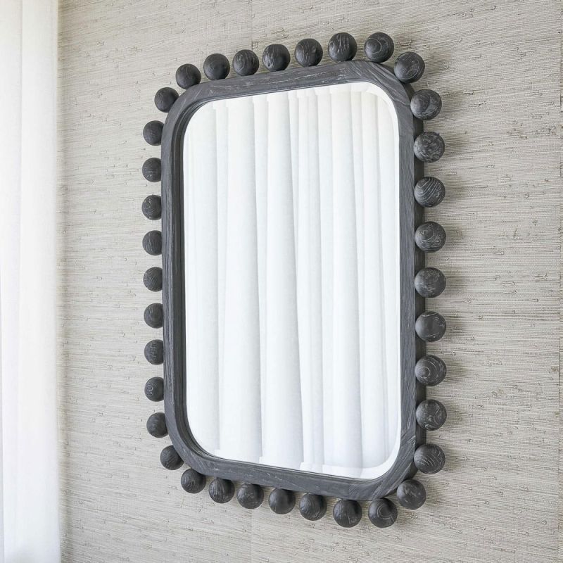 Wall mirror lined with black wooden spheres