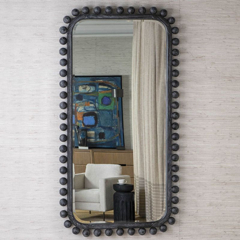 Tall black wooden dressing mirror with ball details along the frame