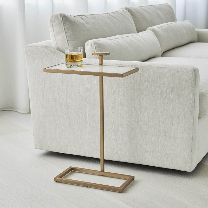 Elegant and understated tall side table with white surface and brass frame