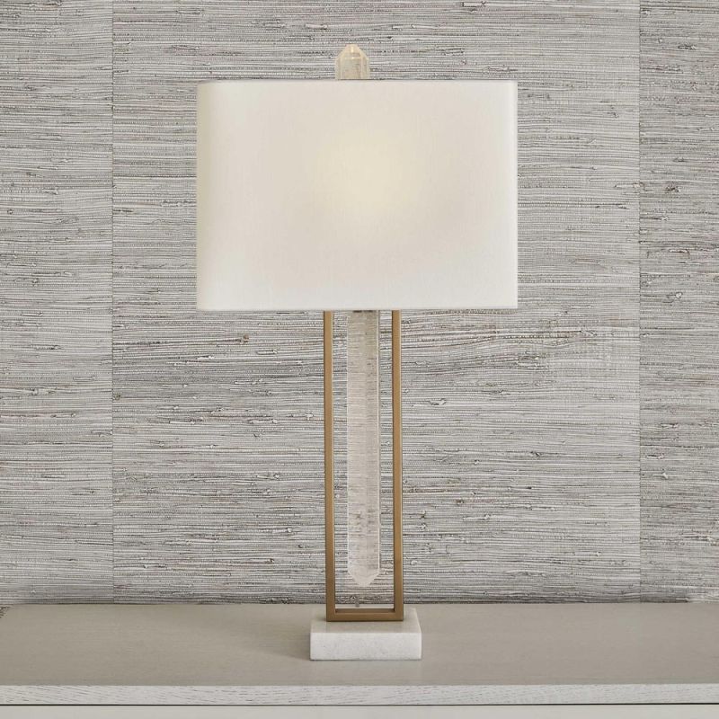 Rich brass table lamp with floating crystal quartz between metal frame