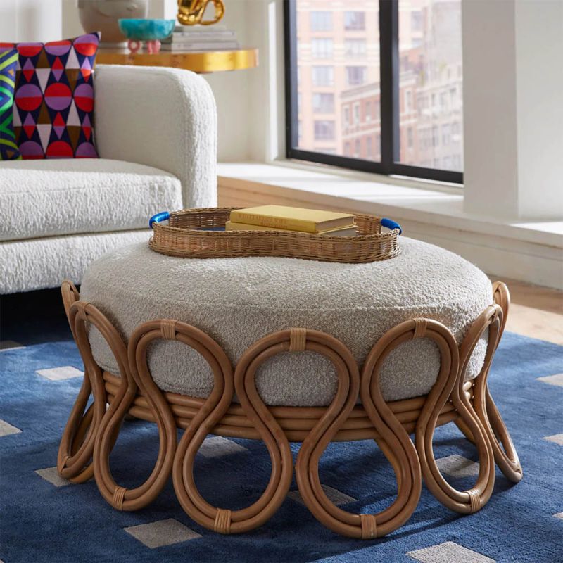 A gorgeous ottoman by Jonathan Adler with a stylish boucle upholstery and sinuous natural framework