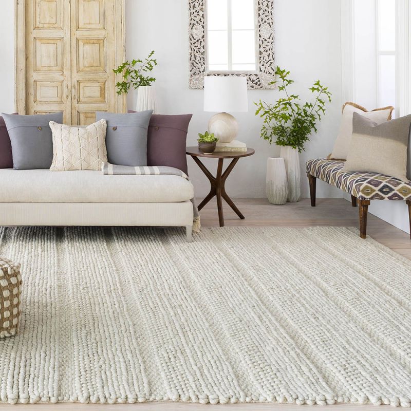 Ivory handwoven rug with loops, knots and basket weave patterns