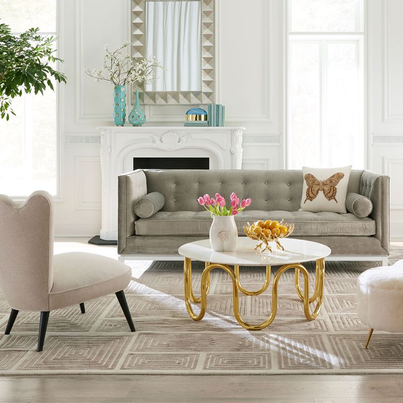 contemporary marble table with a single sinuous brass tube base 