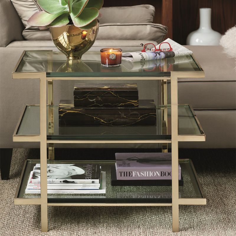A glamorous gold end table by Caracole with a mid-century modern appeal