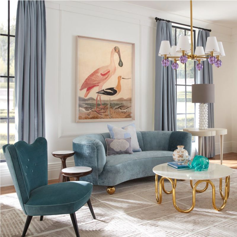 The Parker Curved Sofa offers chic après-ski style with a gentle curve and luxurious velvet or Teddy upholstery, finished with polished brass orb feet.