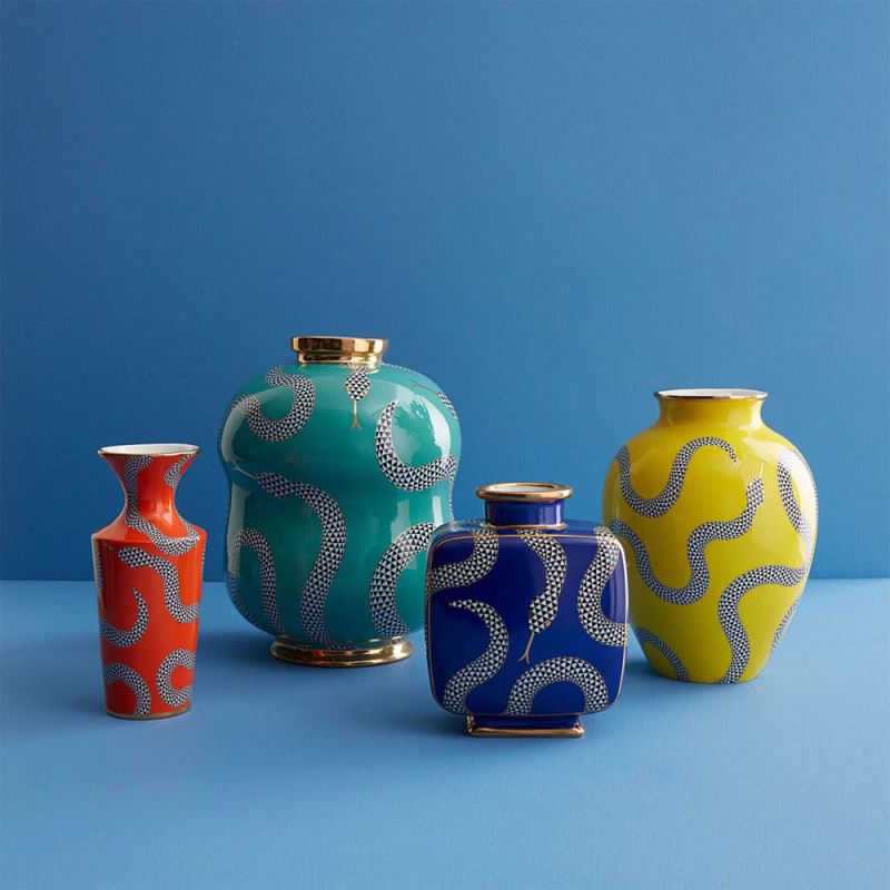 A teal curvaceous vase by Jonathan Adler with white and gold snake illustrations