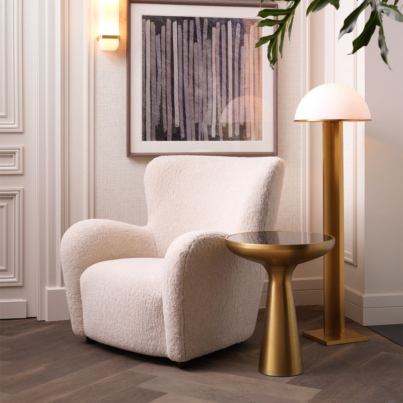 Luxurious fluffy cream-coloured mid-century inspired armchair with black feet