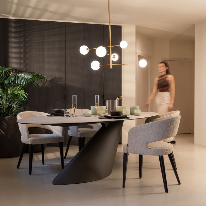 A luxury dining table by Dome Deco with a stylish ceramic table top and unique base