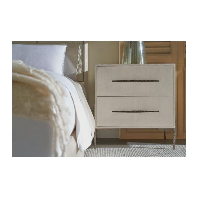 White wooden bedside table with textured cast metal base