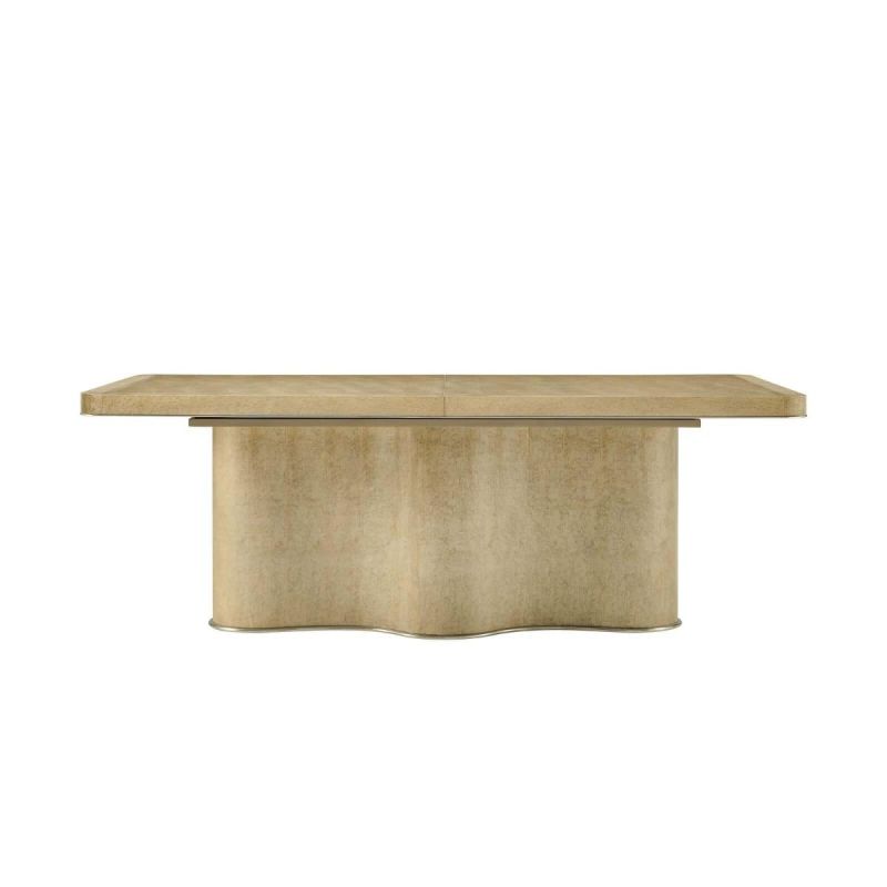 Extendable wooden table with brass trim and scalloped base