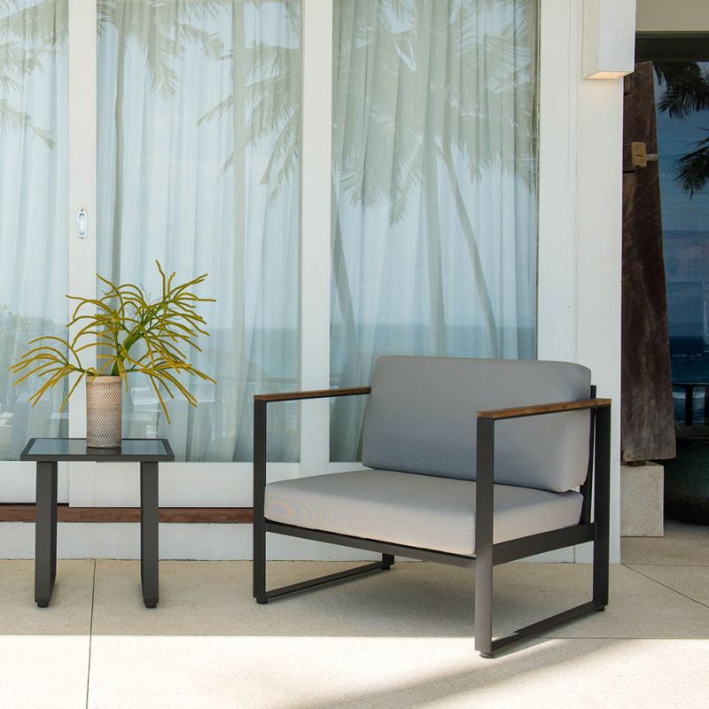 Industrial style armchair with bespoke fabric cushions and black metal frame with wooden armrests