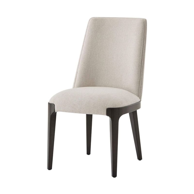 A sophisticated dining chair with a grey upholstery, plush seat and dark tapered legs