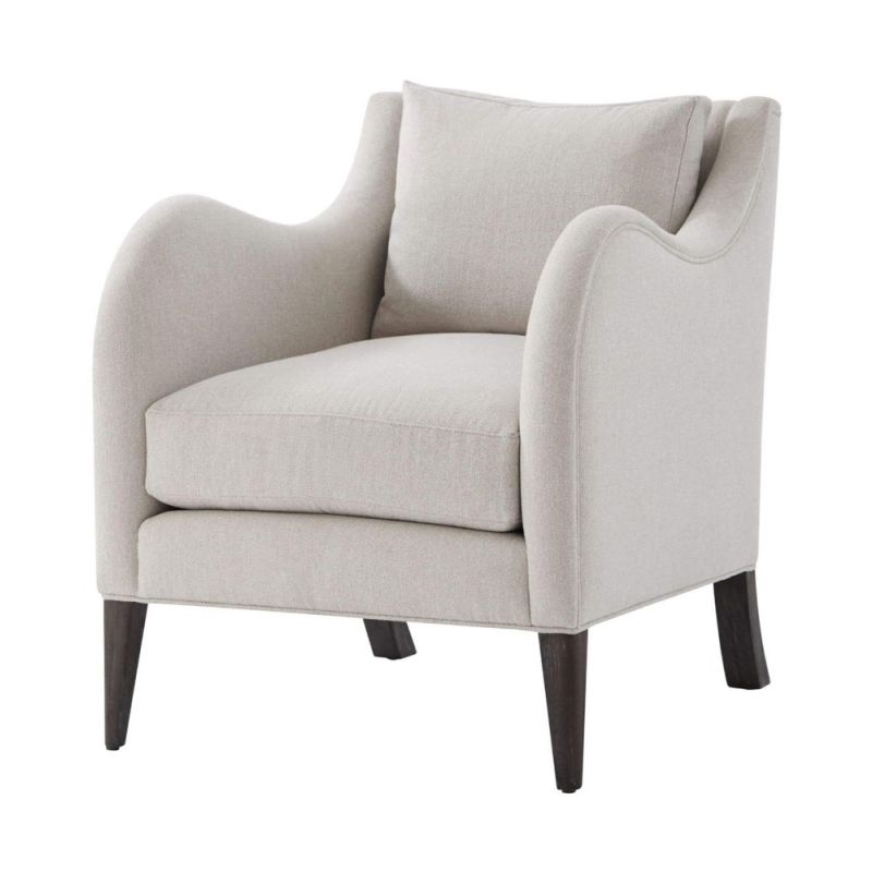 A stylish armchair with a grey upholstery, chic curves and wavy armrests 