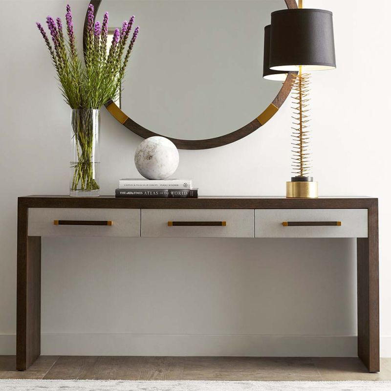 Elegant, modern console table with three drawers and brass accents