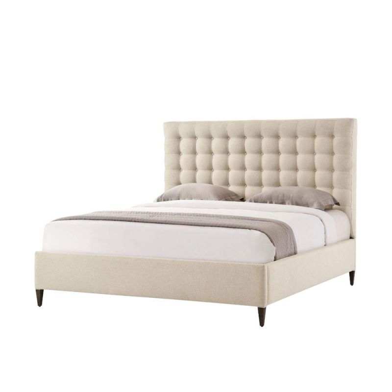 A sumptuous bed with a padded deep buttoned back and cream finish