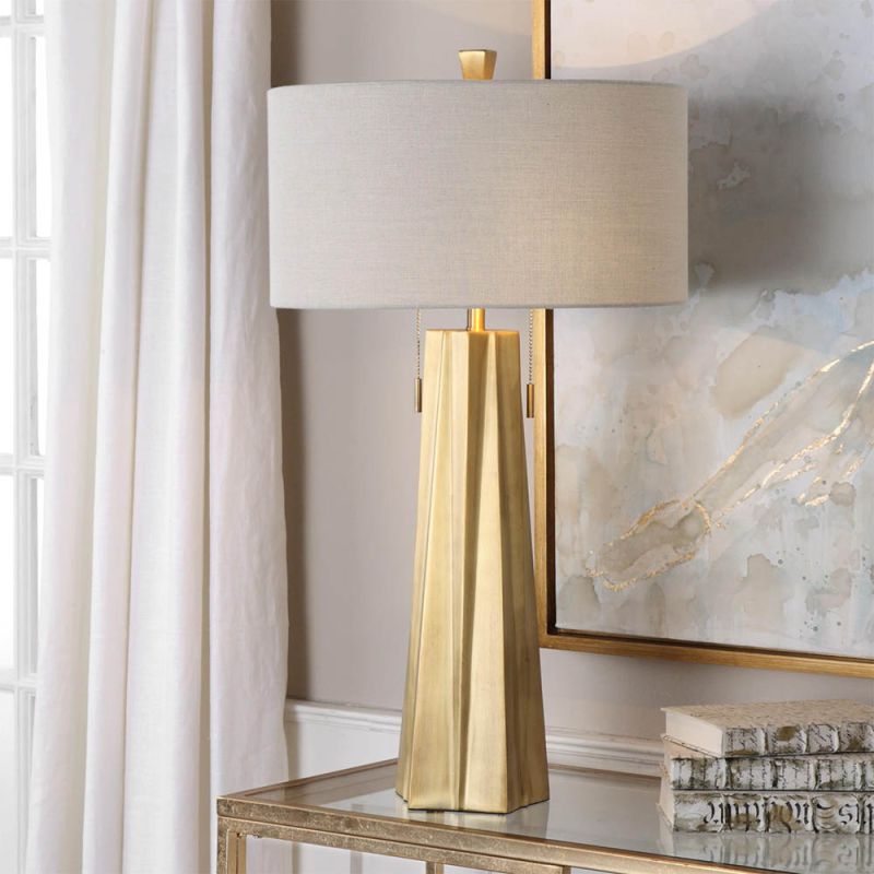 Inverted star shape brass lamp base with light beige linen shade