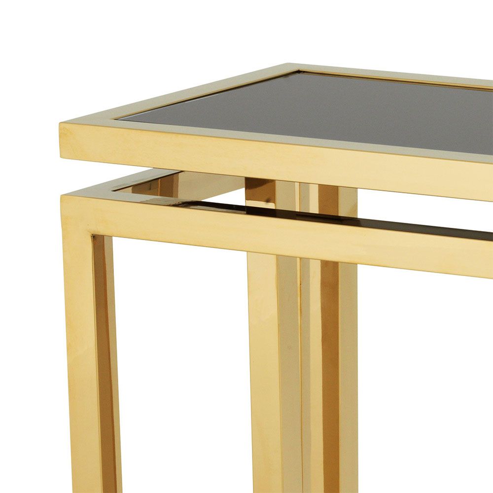 Luxurious gold console table with sleek black glass top. 