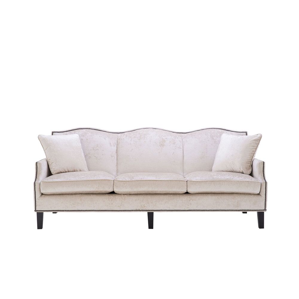 velvety off-white 3 seater sofa with bronze accents and black tapered legs 