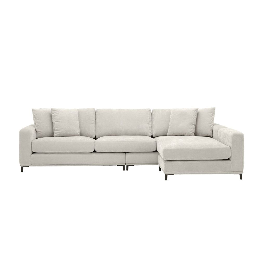 sand coloured L shaped sofa with black legs and four scatter cushions 