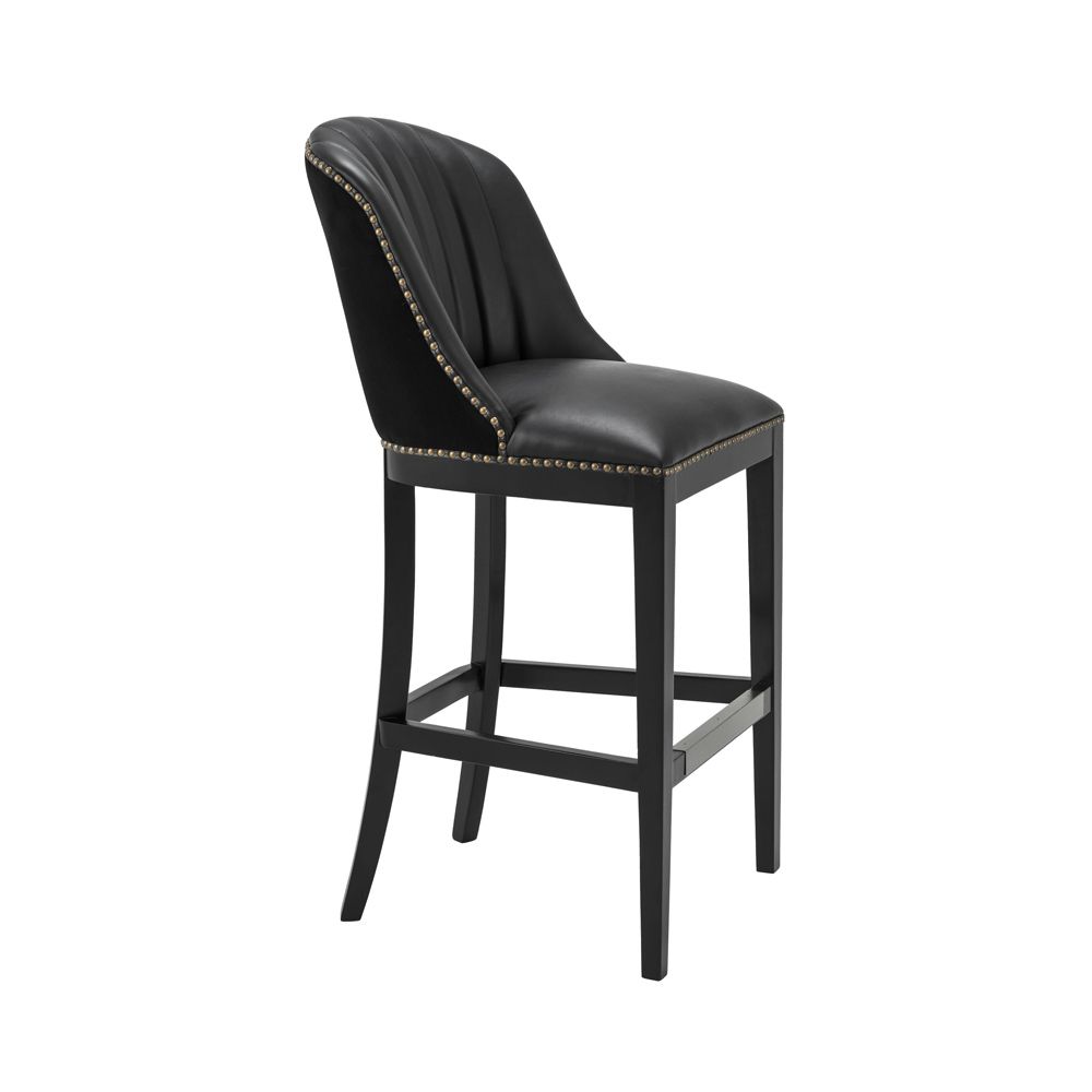 A chic black leather and velvet bar stool with antique brass studding