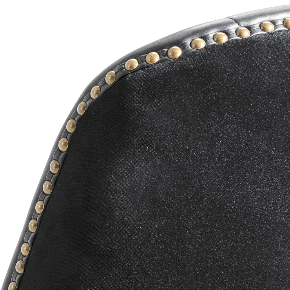 A chic black leather and velvet bar stool with antique brass studding