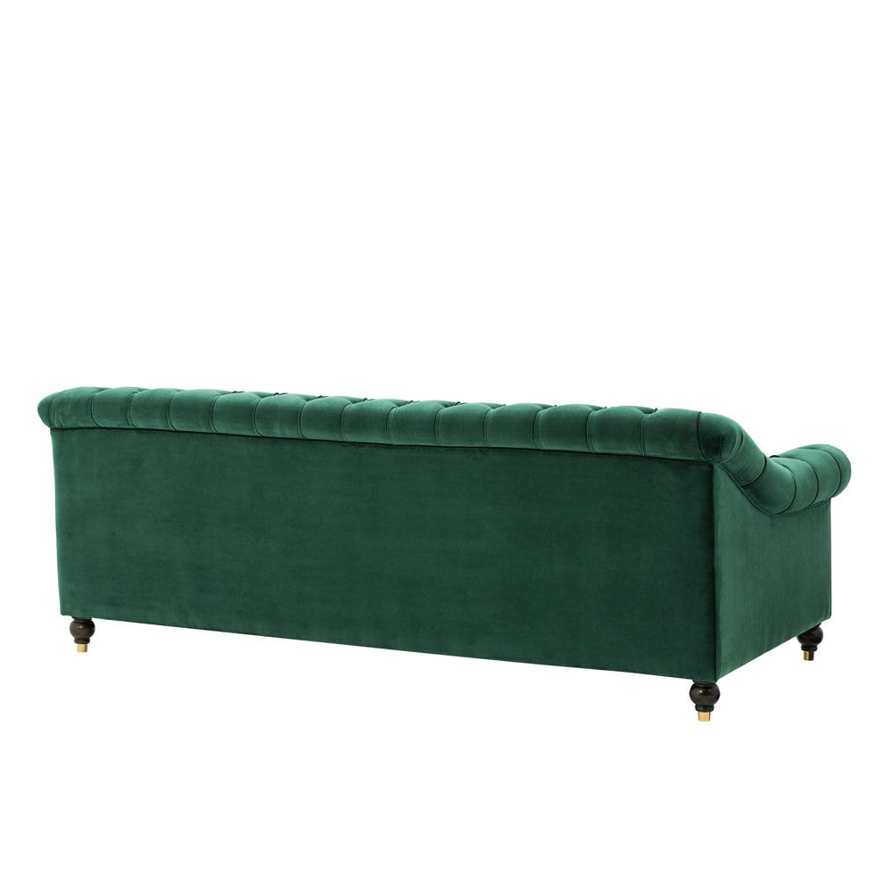 green velvet sofa with buttoning and brass accents 