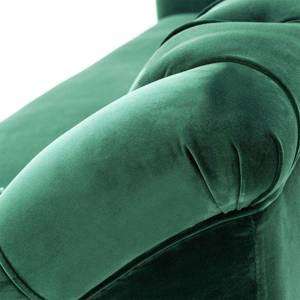 green velvet sofa with buttoning and brass accents 
