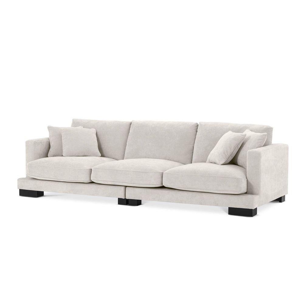 Luxurious large Eichholtz sofa with black feet, available in white, grey and sand