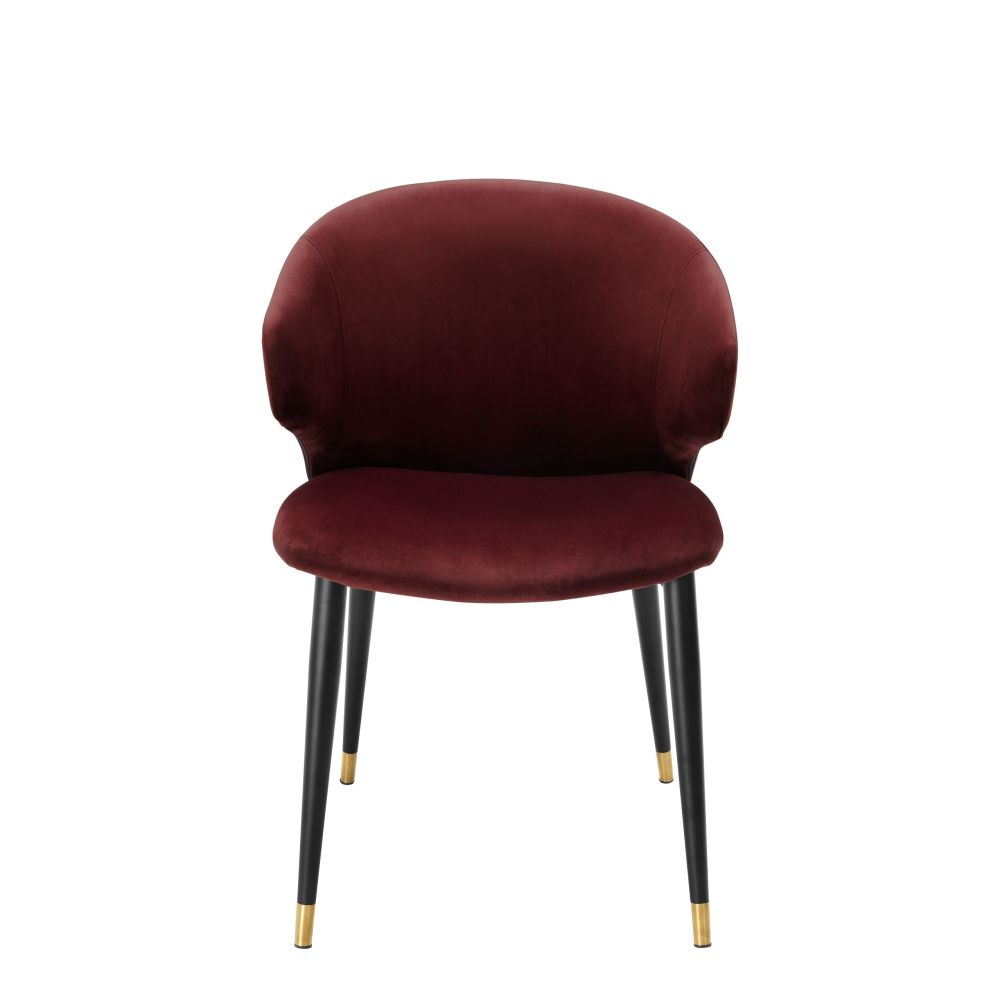 Luxury red velvet dining chair with black and gold tapered legs