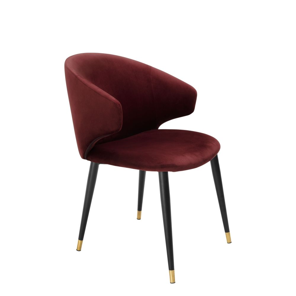 Luxury red velvet dining chair with black and gold tapered legs
