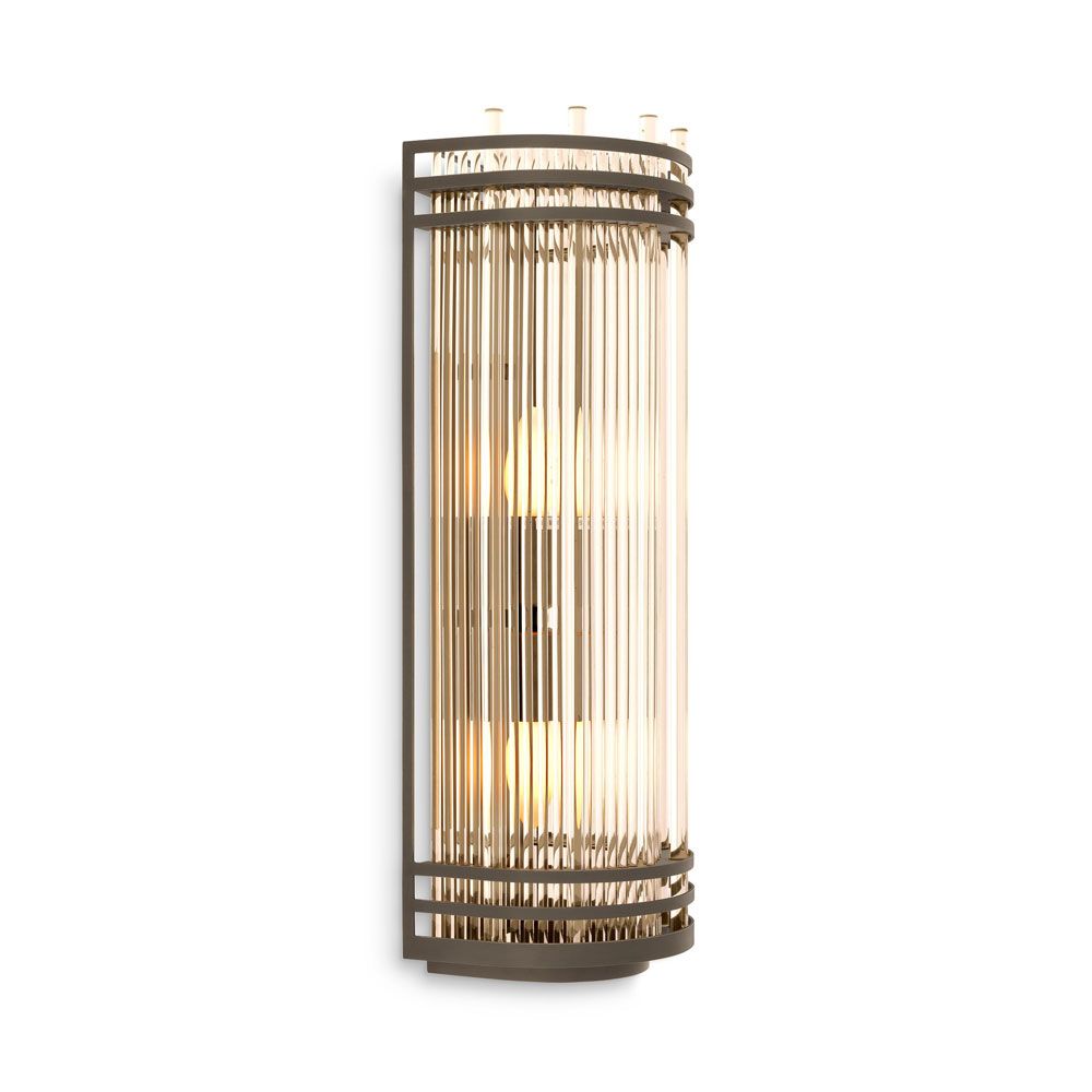 An elegant bronze and clear glass wall lamp