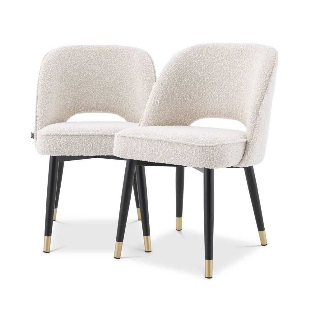 Stunning upholstered chair with black tapered legs and brass caps. 