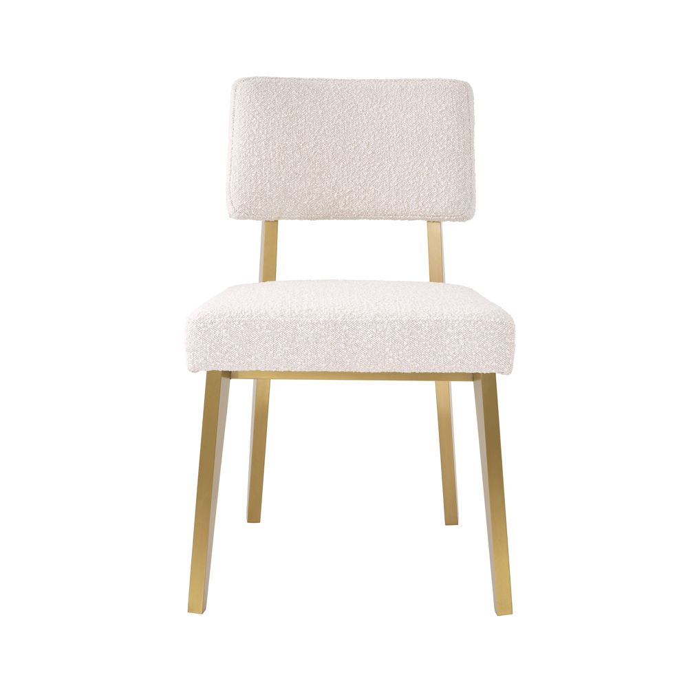A luxurious modern brushed brass and boucle dining chair 