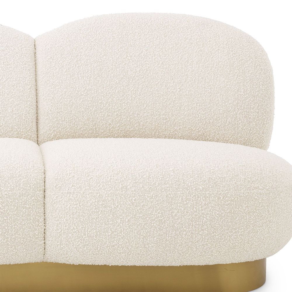 A fabulous three-seater boucle cream-upholstered sofa