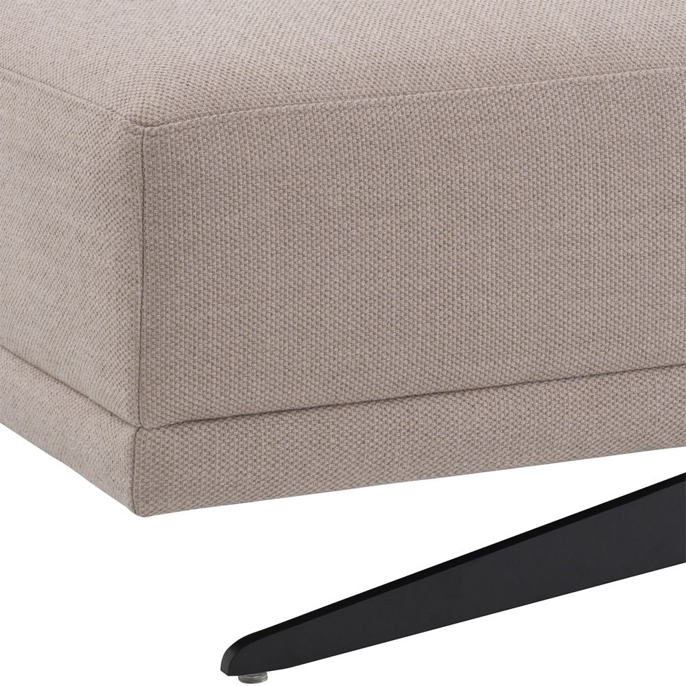 A luxurious avalon sand ottoman with black legs by Eichholtz