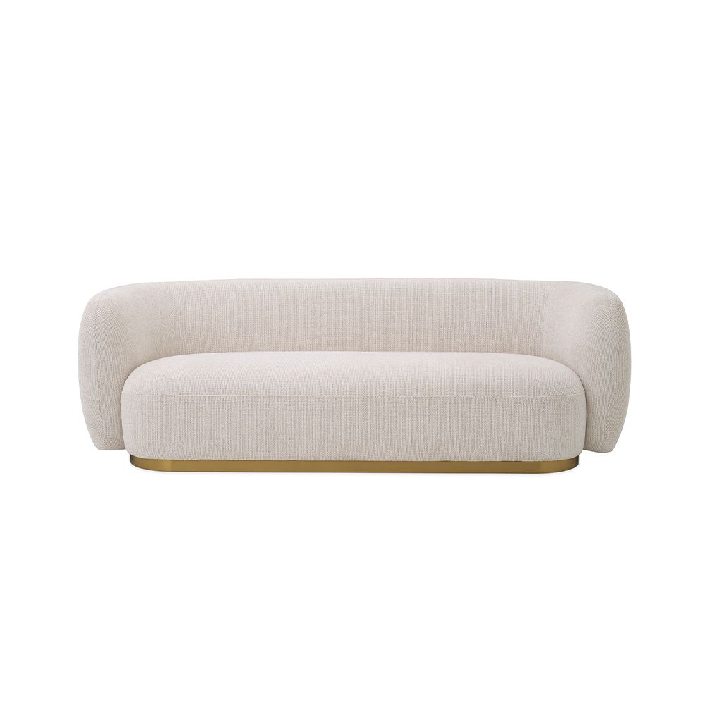 A sumptuous sofa by Eichholtz with an Lyssa Off-White upholstery and brushed brass base 