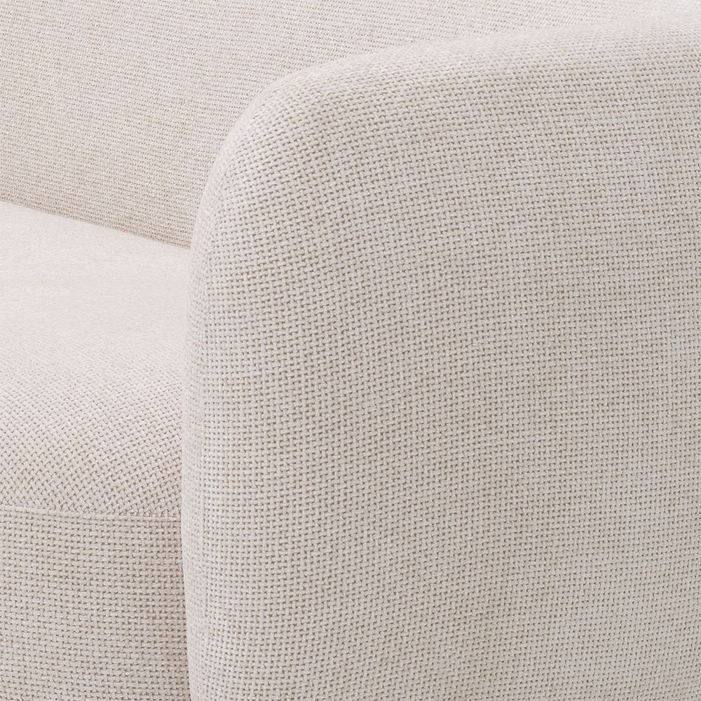 A sumptuous sofa by Eichholtz with an Lyssa Off-White upholstery and brushed brass base 