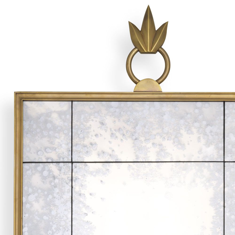 Gorgeous, antiqued wall mirror with ornamental top and brass frame