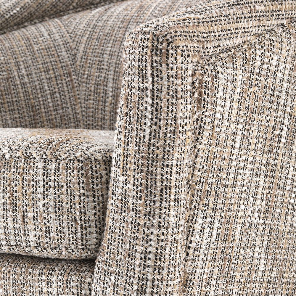 A woven beige armchair with a matte gold swivel base
