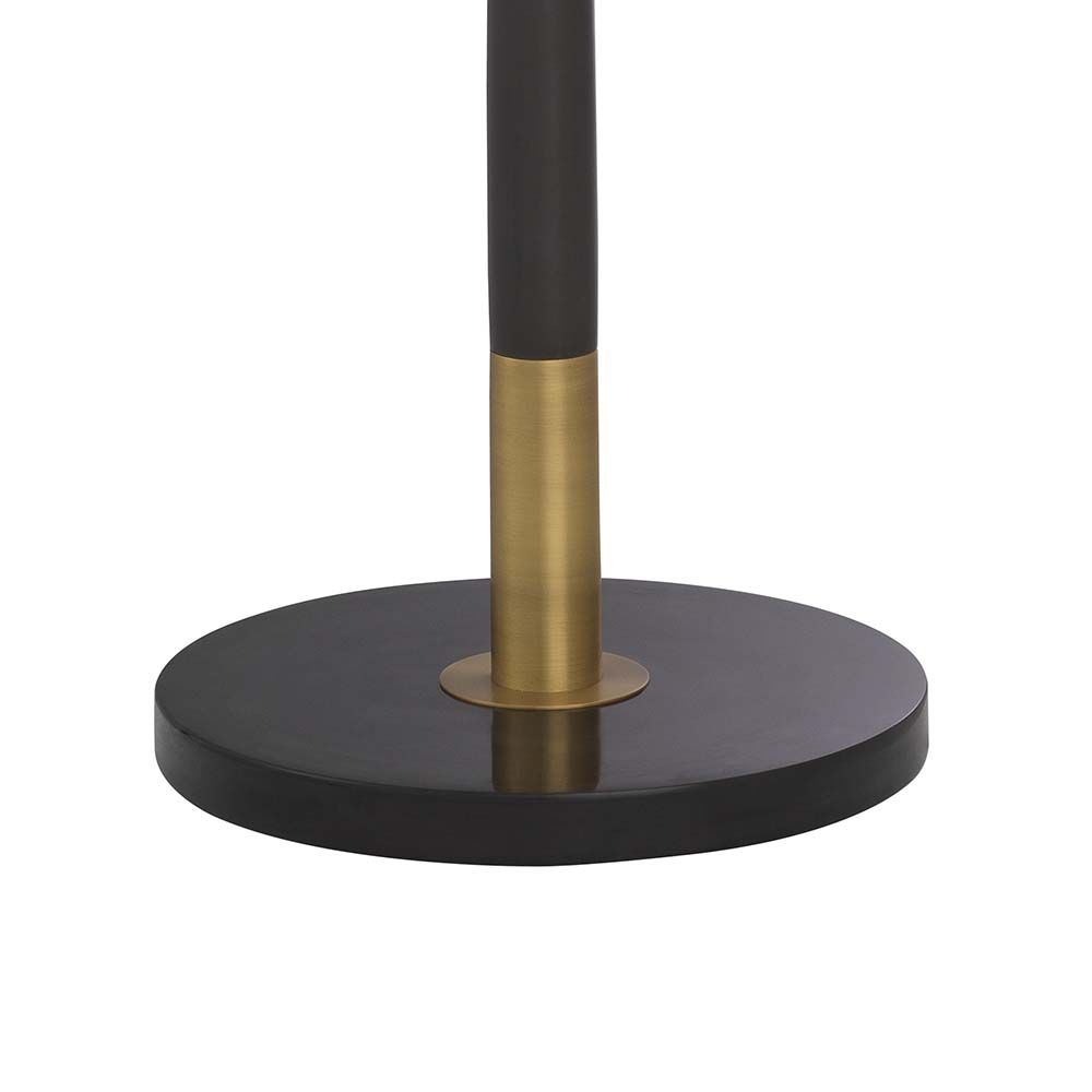 Asymmetrical floor lamp on a marble bass with an abstract brass ornament.
