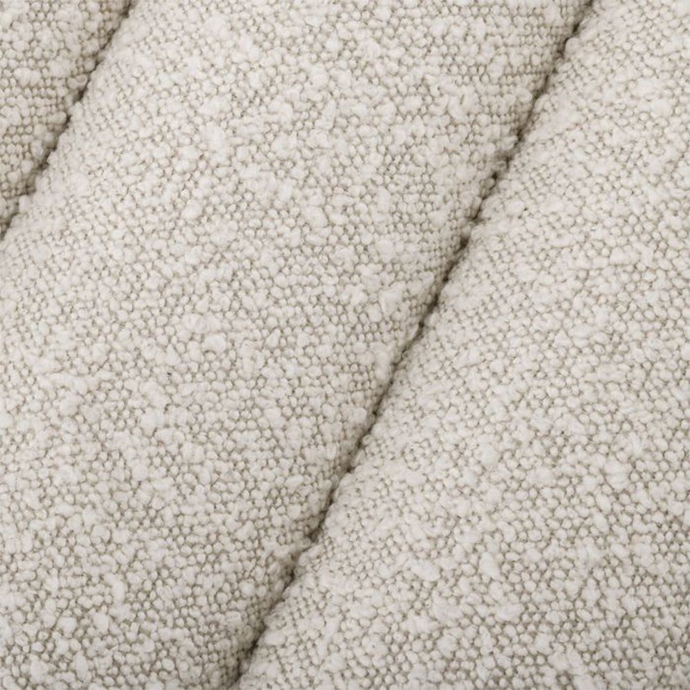 A stylish boucle cream bench with deep channel stitching by Eichholtz