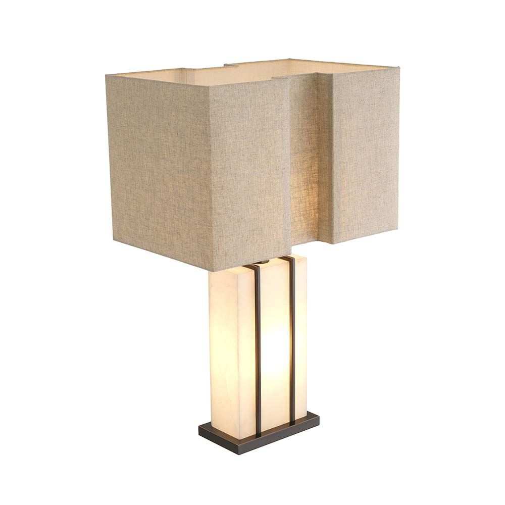 A contemporary table lamp with an alabaster base encased with a brass frame.