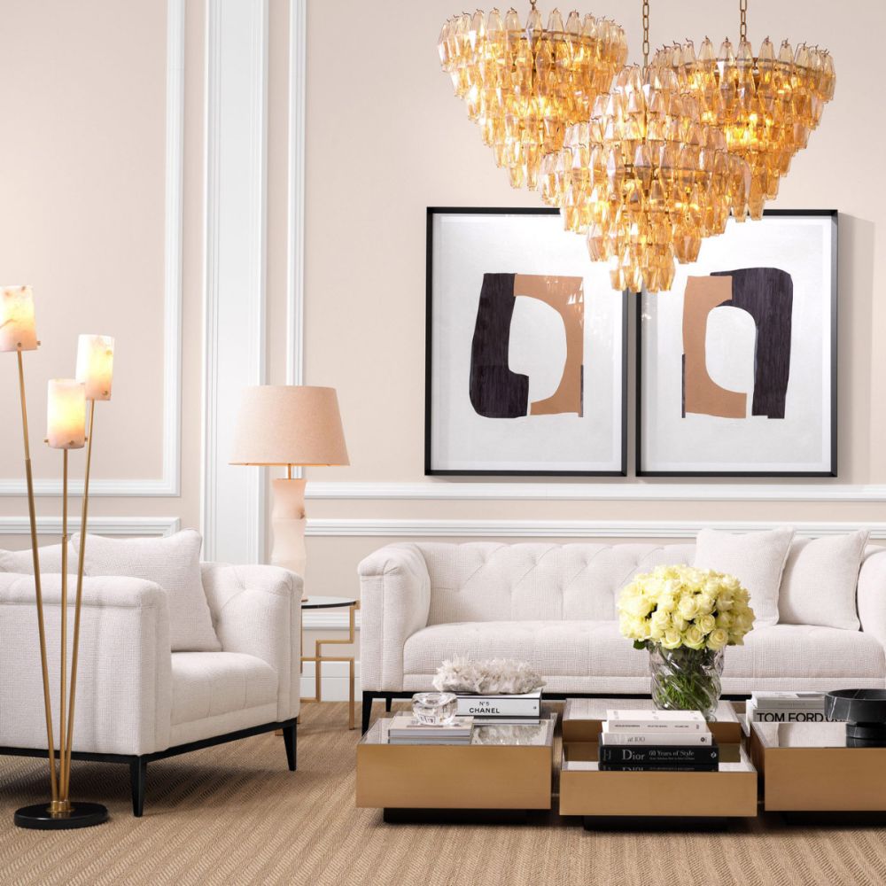 A stylish floor lamp by Eichholtz with three alabaster lamp holders fitted on antique brass stems with a honed black marble base