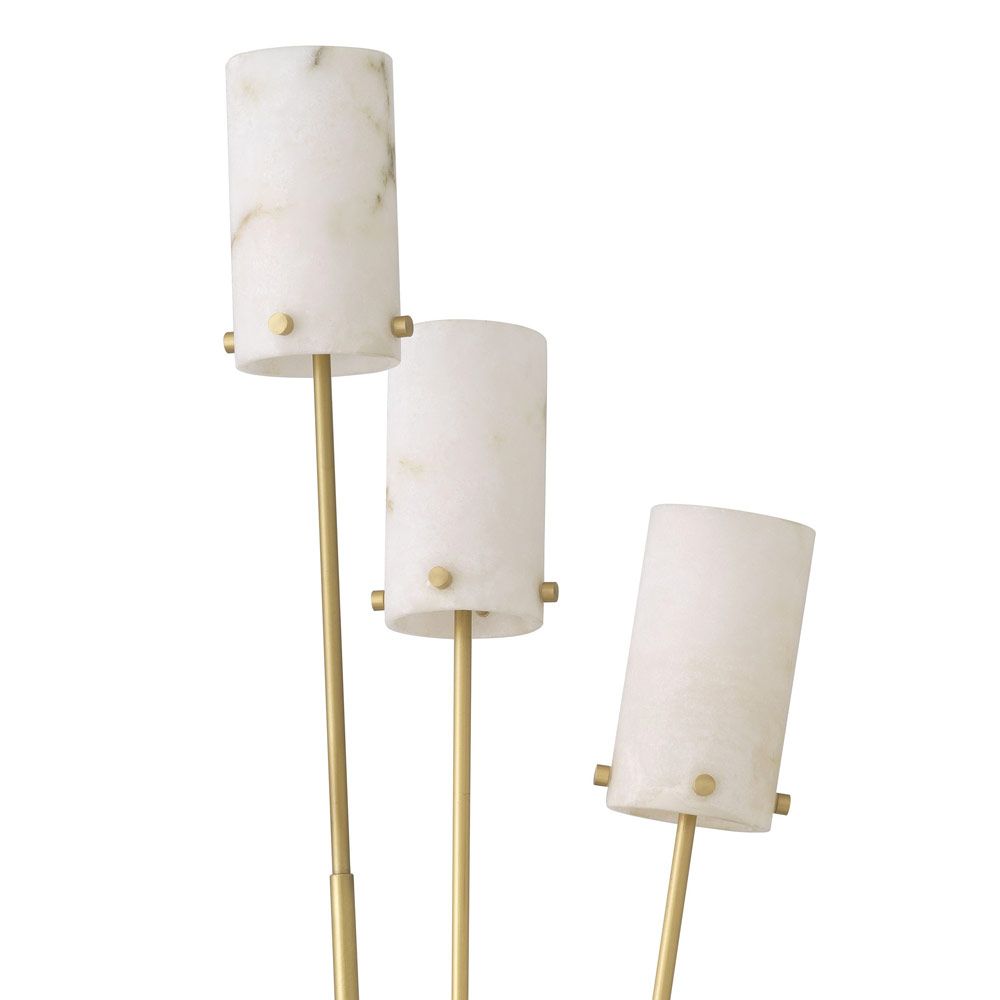 A stylish floor lamp by Eichholtz with three alabaster lamp holders fitted on antique brass stems with a honed black marble base