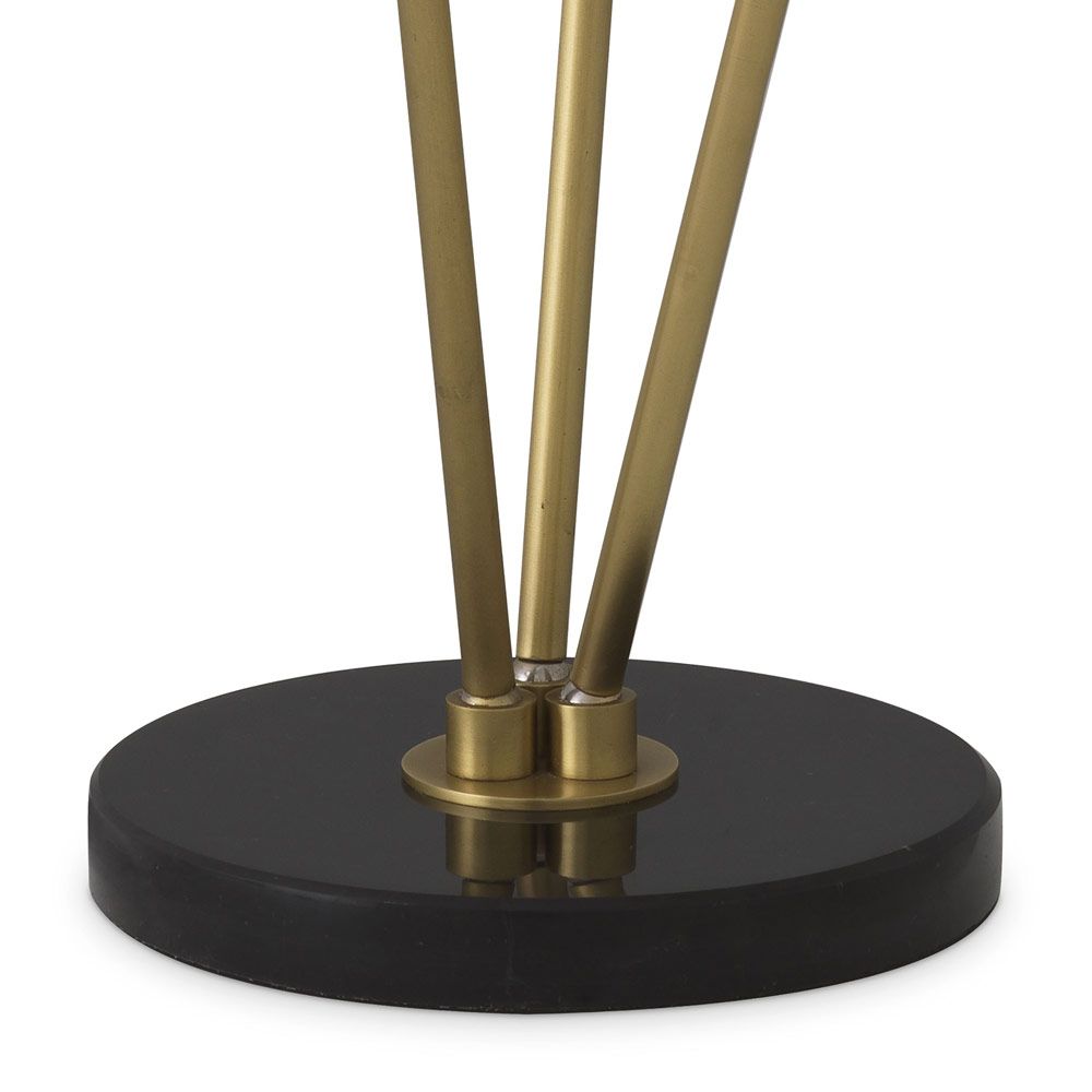 A stylish floor lamp by Eichholtz with three alabaster lamp holders fitted on antique brass stems with a honed black marble base